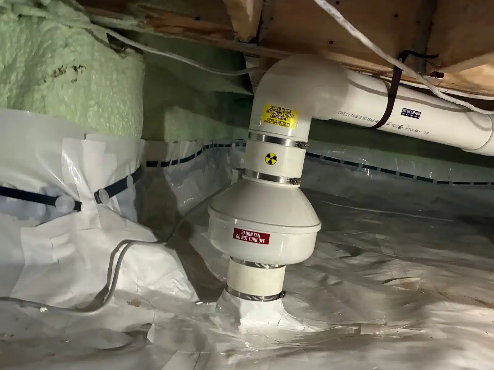 Radon Fan Sealed Into A New Crawlspace Membrane Near Blind Bay