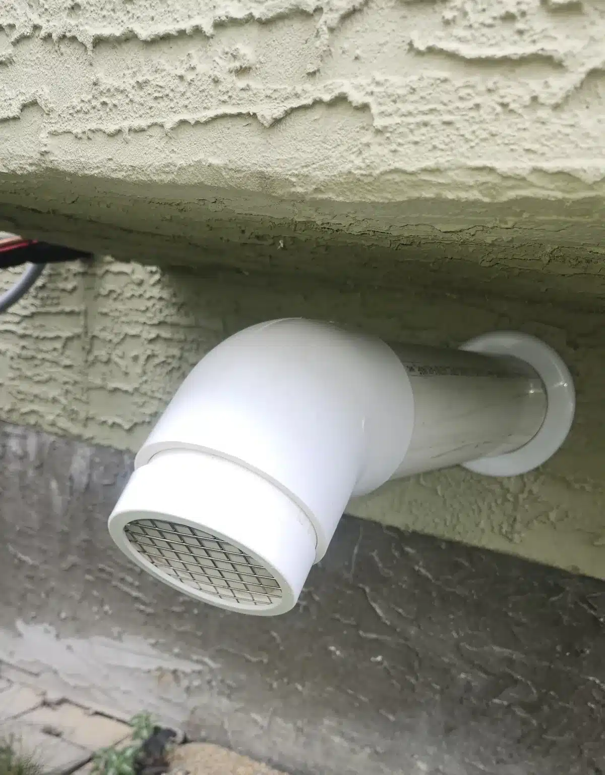 Radon Discharge Vent Through A Stucco Wall In Okotoks
