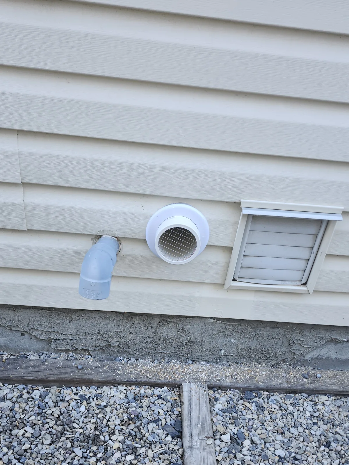 Screened Radon Vent On The Vinyl Siding Of An Okotoks Home