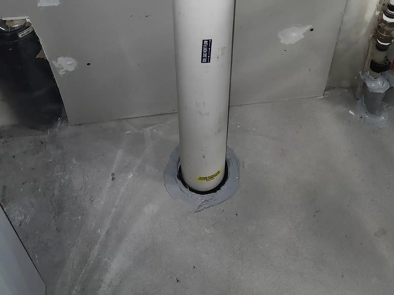 Radon Pipe Sealed Where It Enters The Basement Floor Of An Okotoks Home