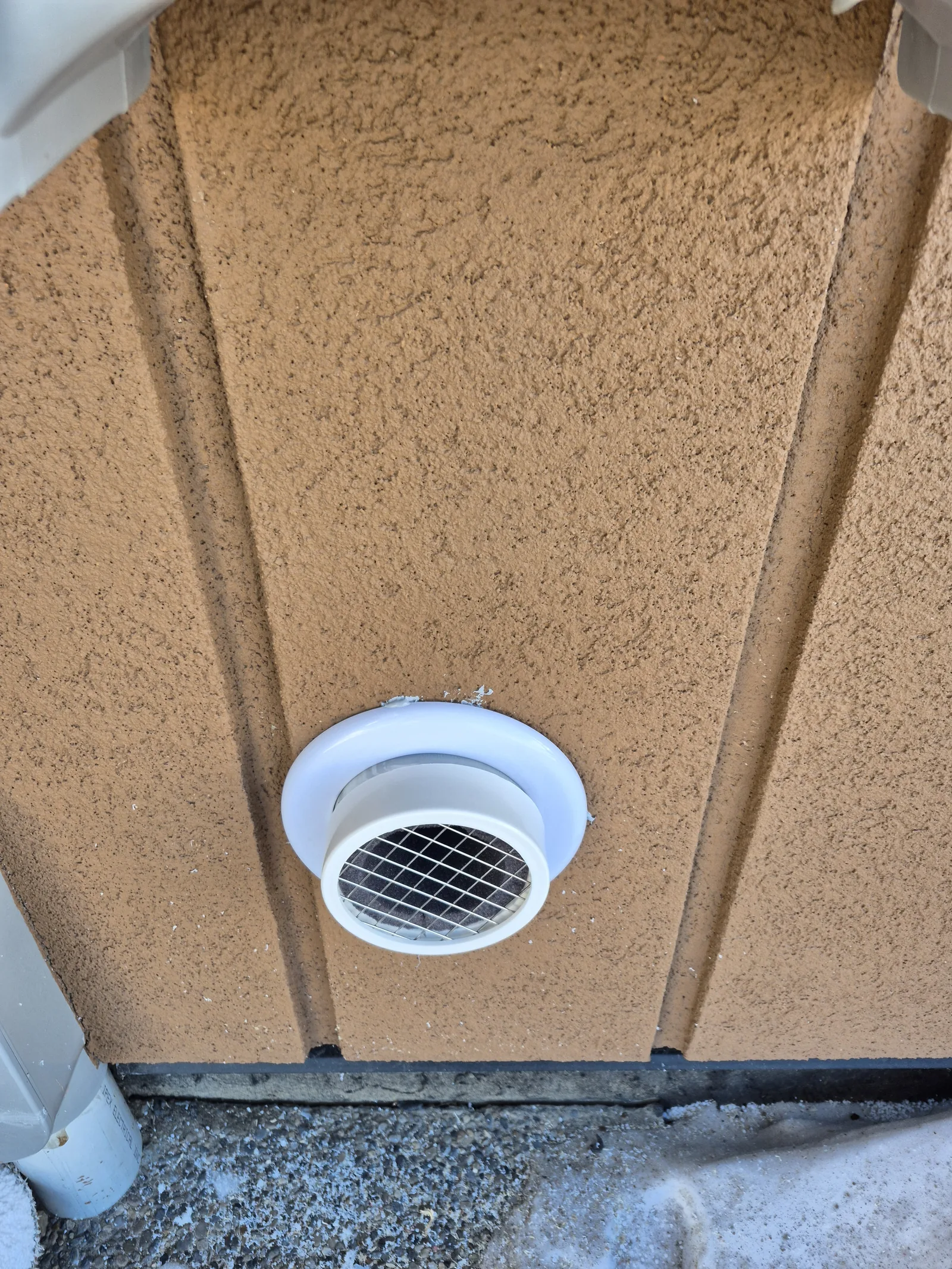 A Radon Discharge Pipe On The Stucco Wall Of A Parkland County Home