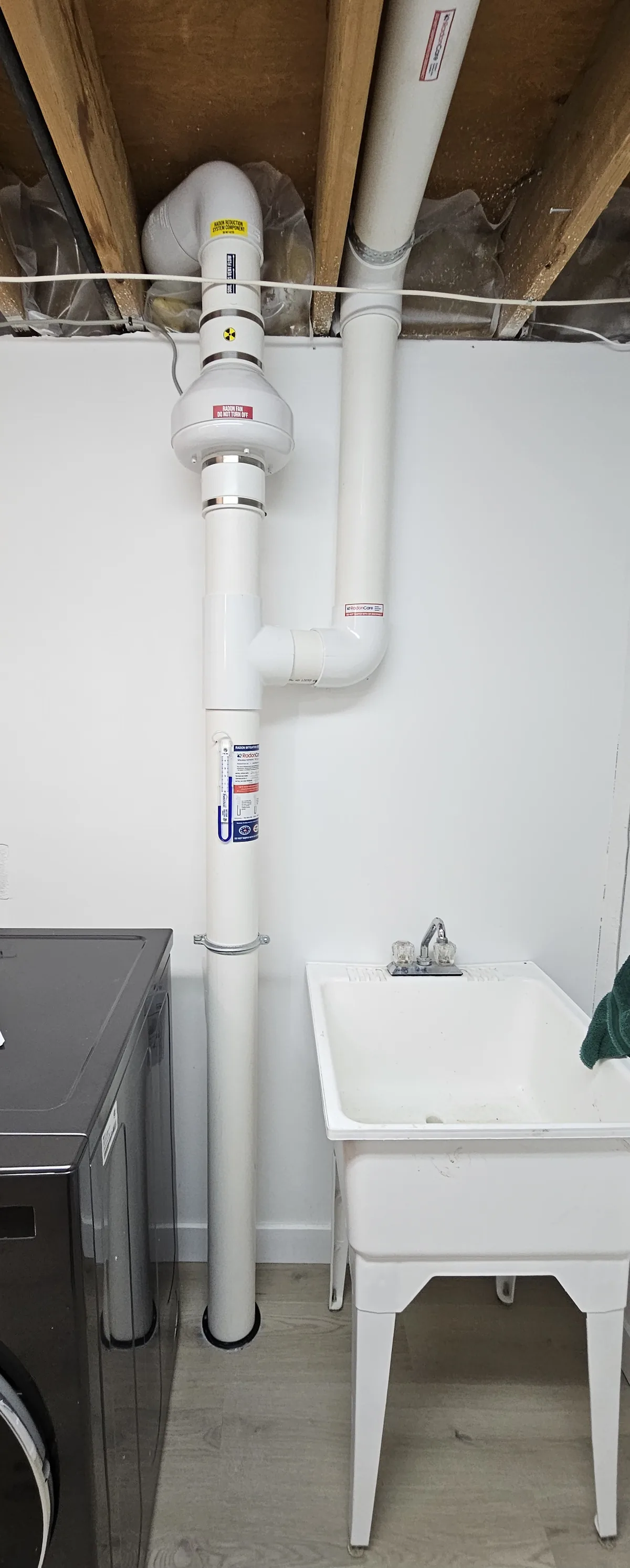 Radon Fan And White Pipe In A Finished Laundry Room In A 1970S St. Albert Bungalow