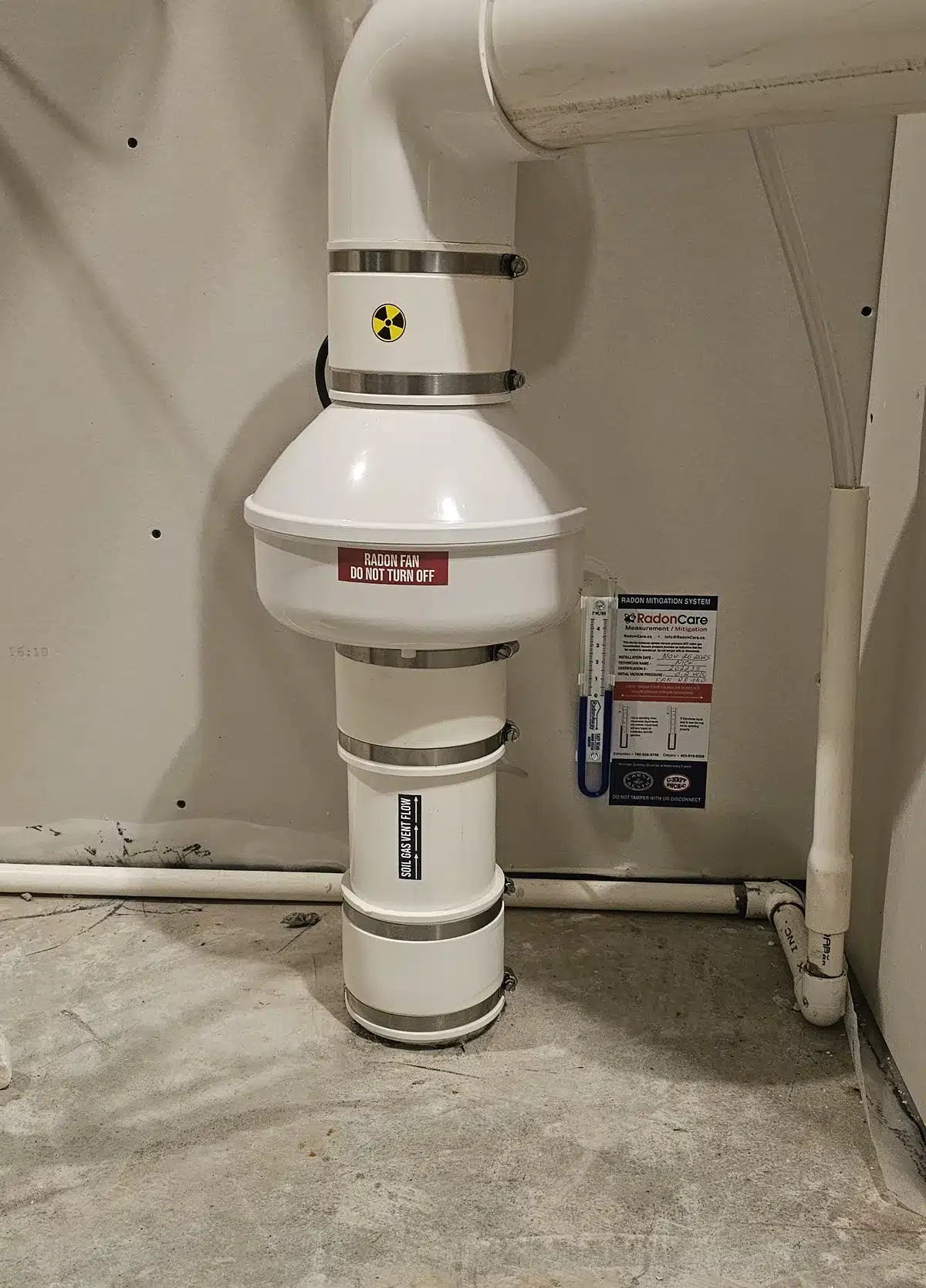 A Radon Fan And Labelled Pipe On A Slab Suction System In An Acreage Home In Strathcona County