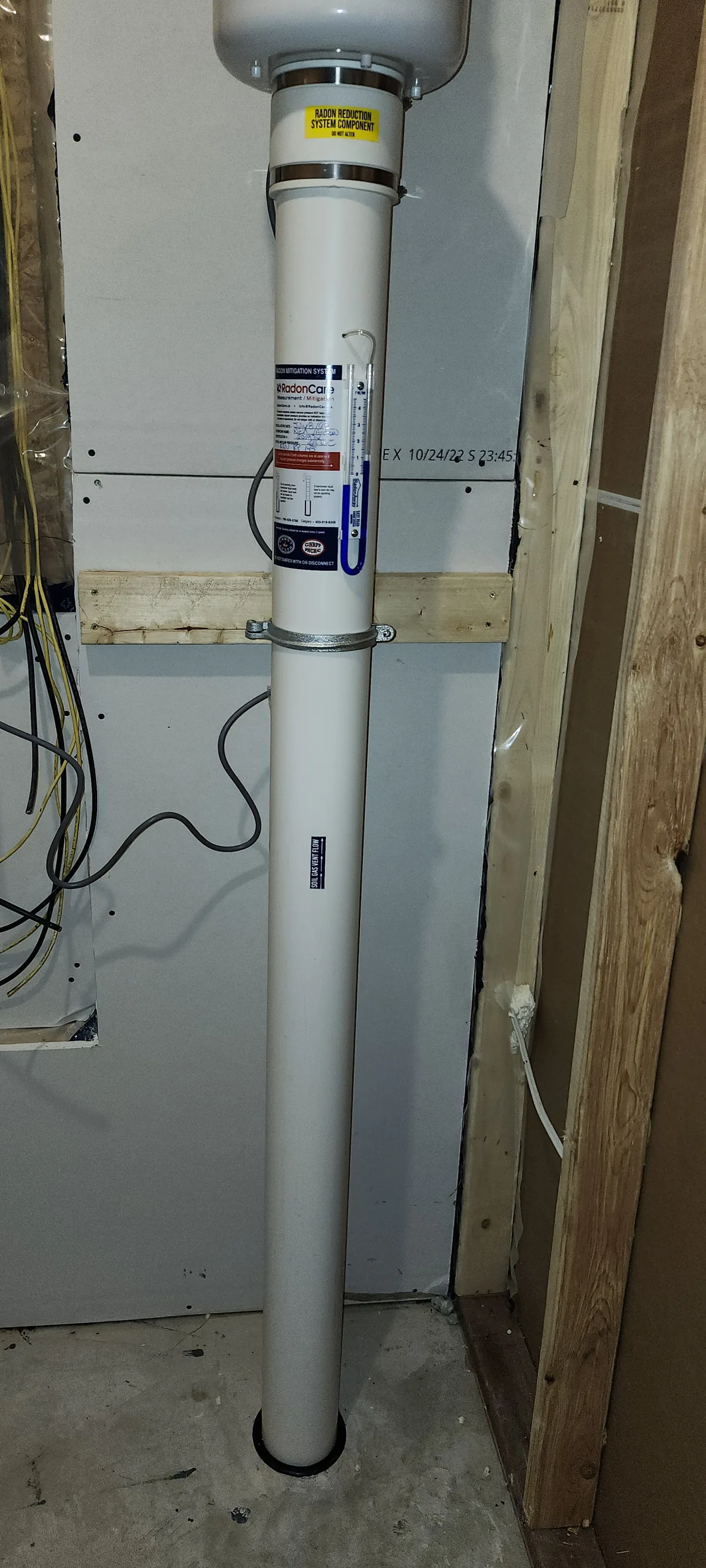 A Radon Pipe Rising Past The System Label In The Unfinished Basement Of A Newer Ardrossan Home