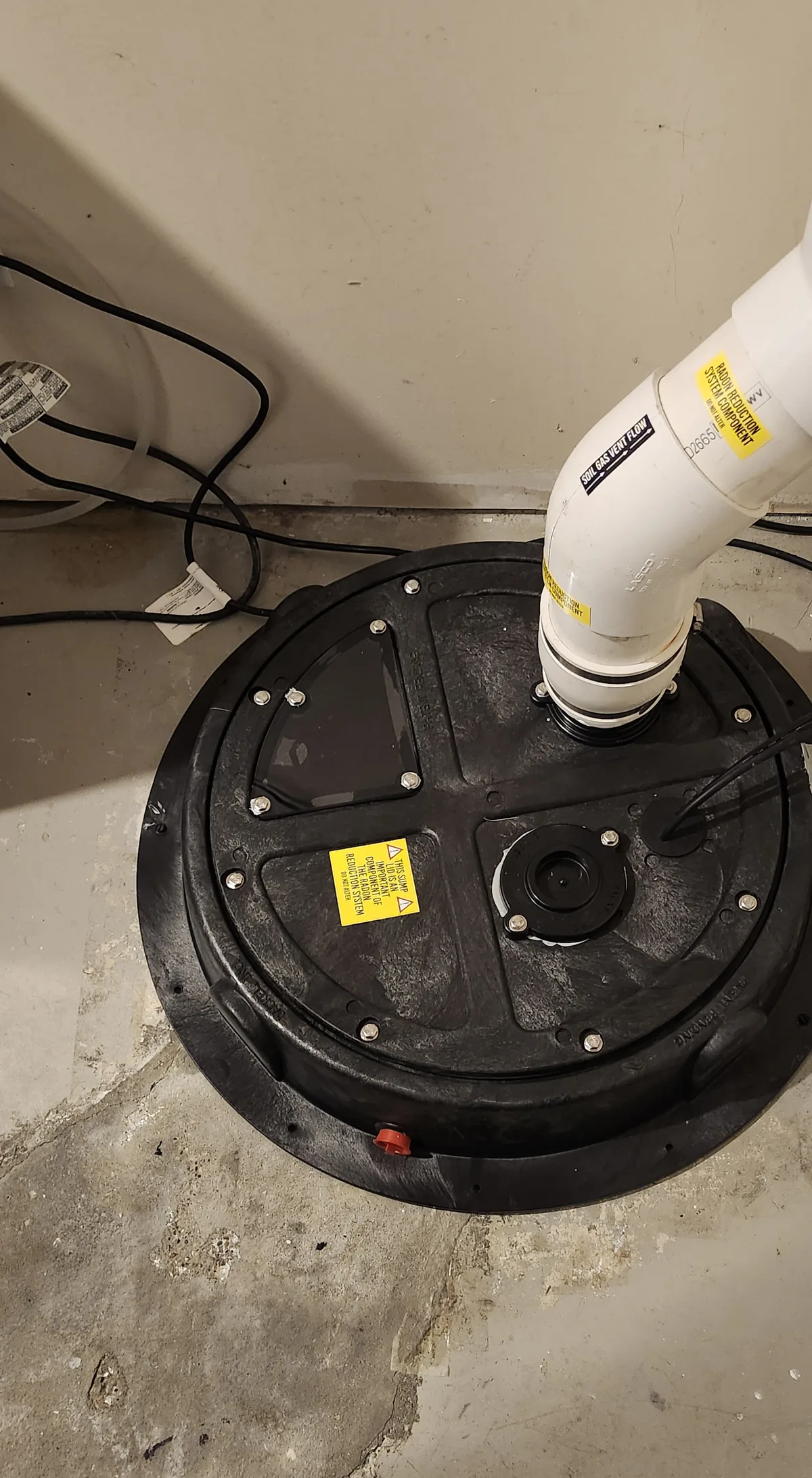Radon Pipe Rising From A Sealed Sump Lid In A Finished St. Albert Basement