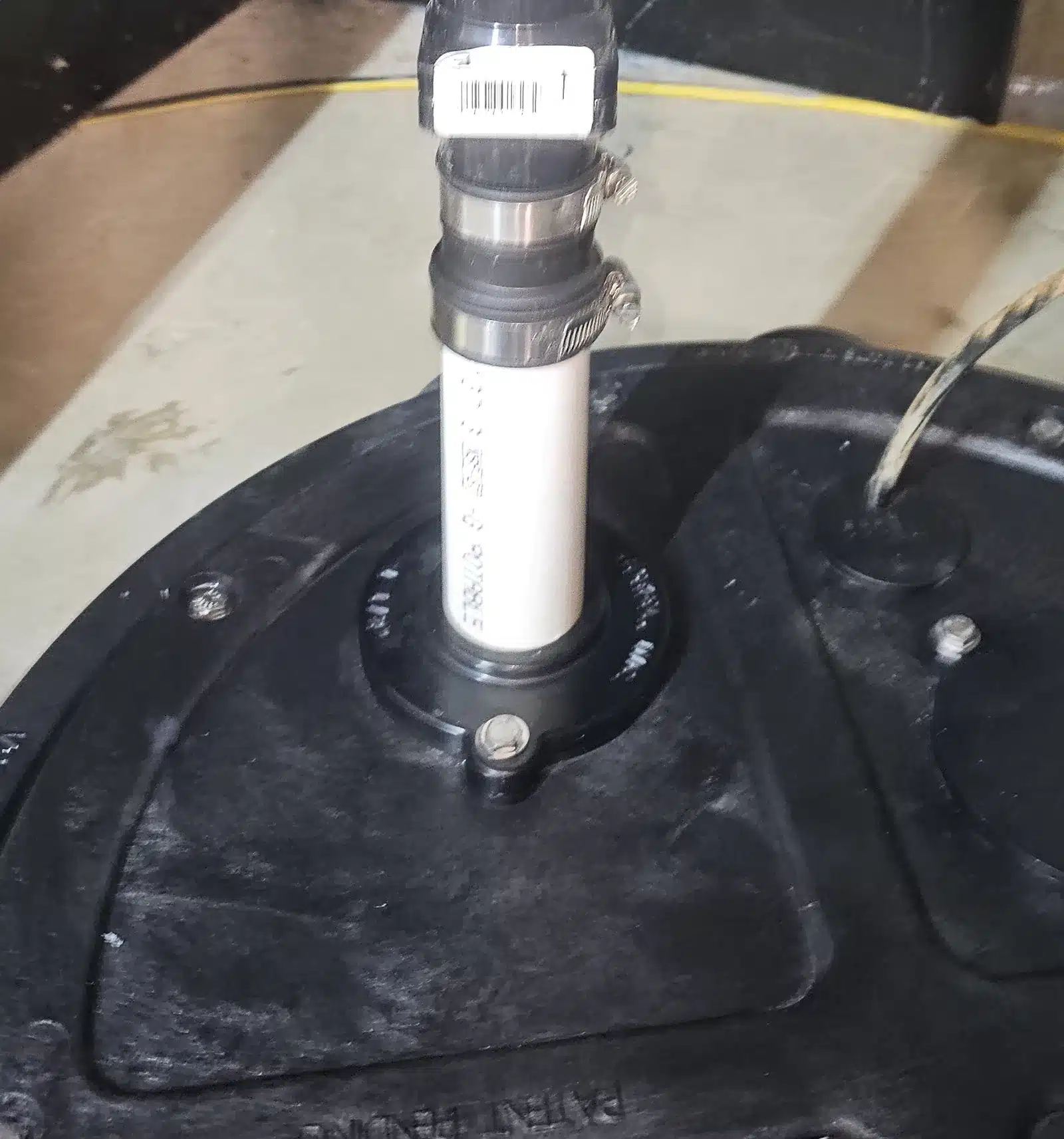 Radon Pipe Rising From A Sealed Black Sump Lid In A Basement Near Spruce Grove