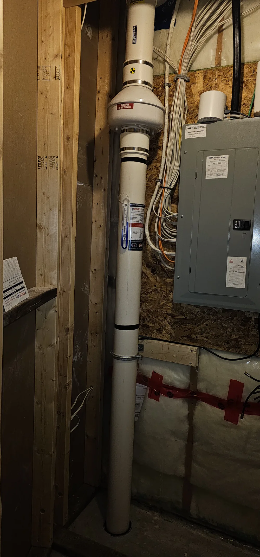 Radon Fan And Pipe In A Framed Basement Wall In A Sylvan Lake Home