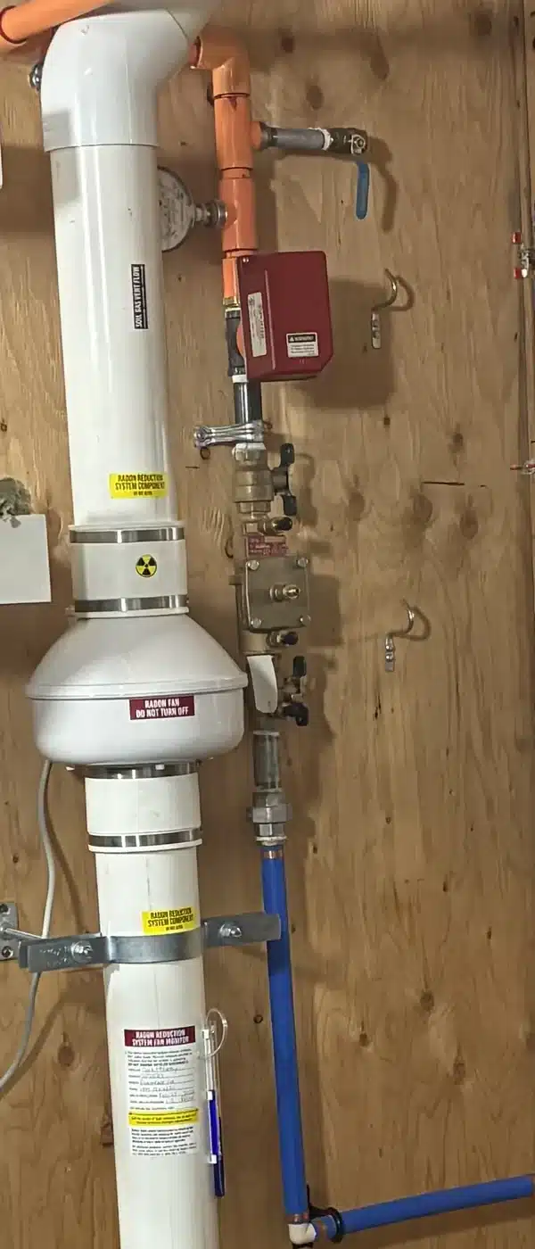Radon Fan And Labelled Pipe In A Utility Room In A Lake Country Home