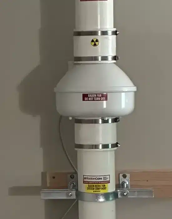 A Radon Fan And Labelled Pipe On A Basement Wall In A West Kelowna Home