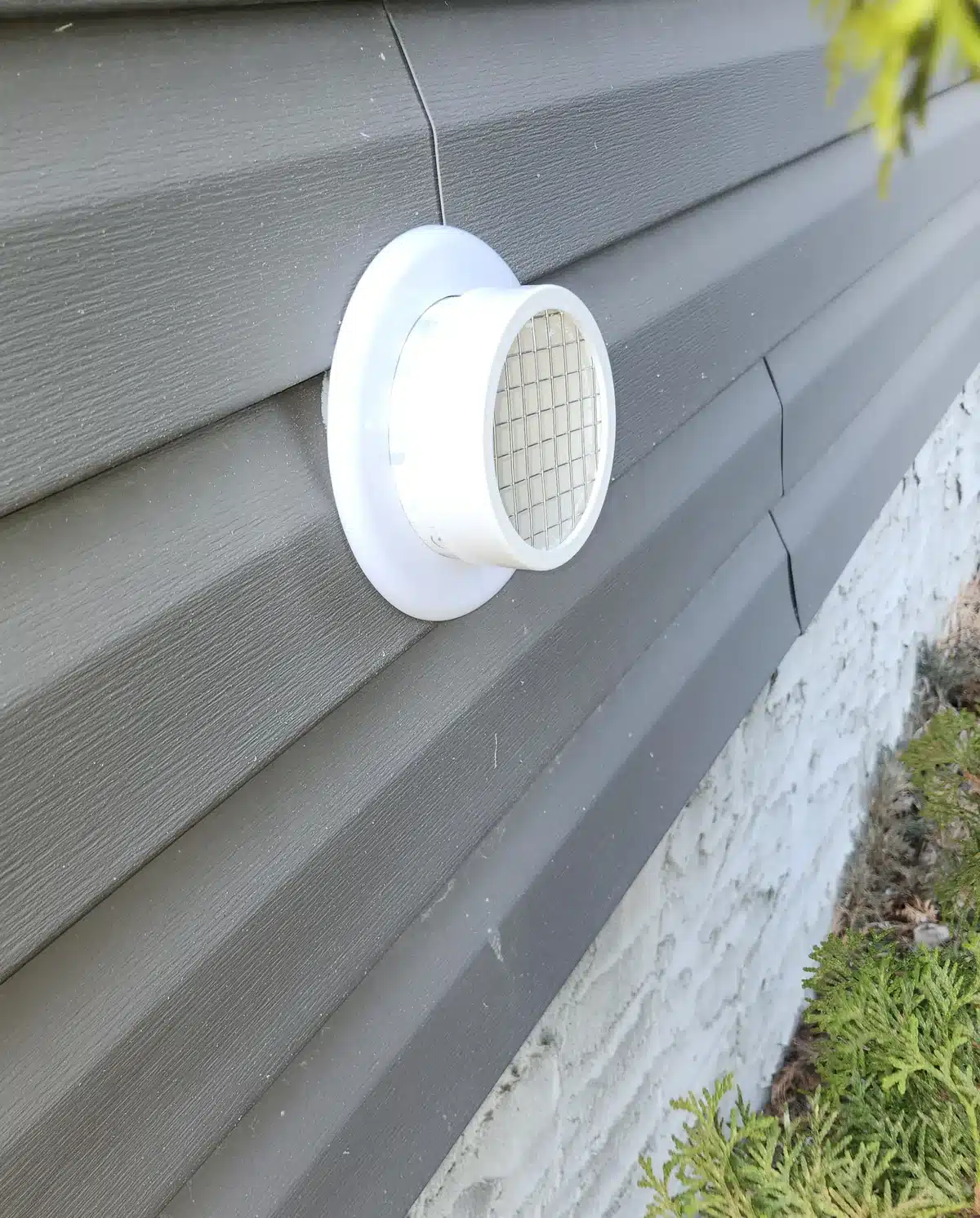 A Screened Radon Vent On The Grey Vinyl Siding Of An Acreage Home Near Sherwood Park